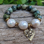 Large white pearl and African turquoise elastic bracelet with heart and butterfly charm by Aurora Creative Jewellery