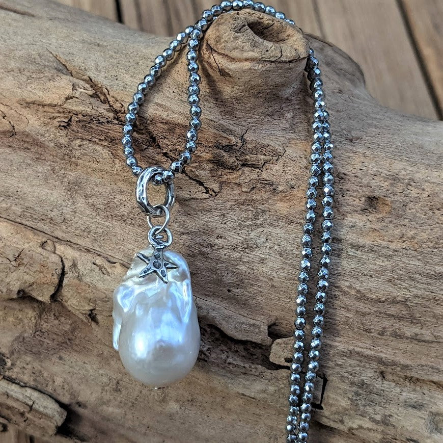 Thin silver hematite and large white baroque pearl pendant necklace with star charm, by Aurora Creative Jewellery
