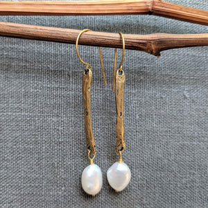 Handmade long thin white baroque pearls and gold bronze drop earrings by Aurora Creative Jewellery