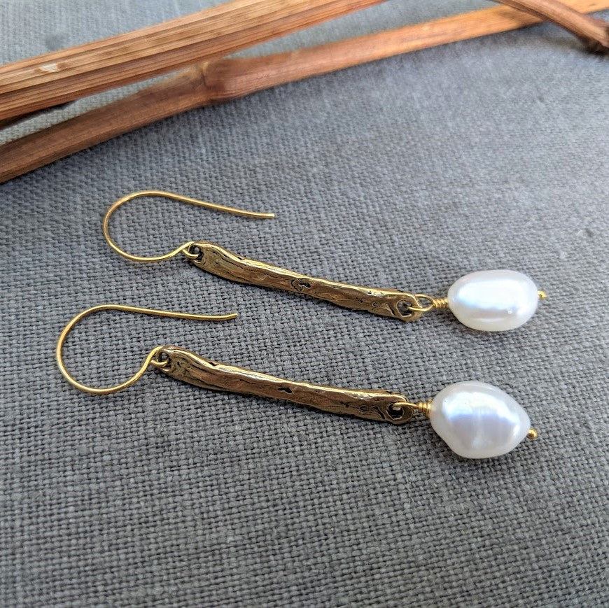 Handmade long thin white baroque pearls and gold bronze drop earrings by Aurora Creative Jewellery