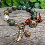 African turquoise bracelet with big white Edison pearl and gold bronze seahorse and shell handcrafted by Aurora Creative Jewellery
