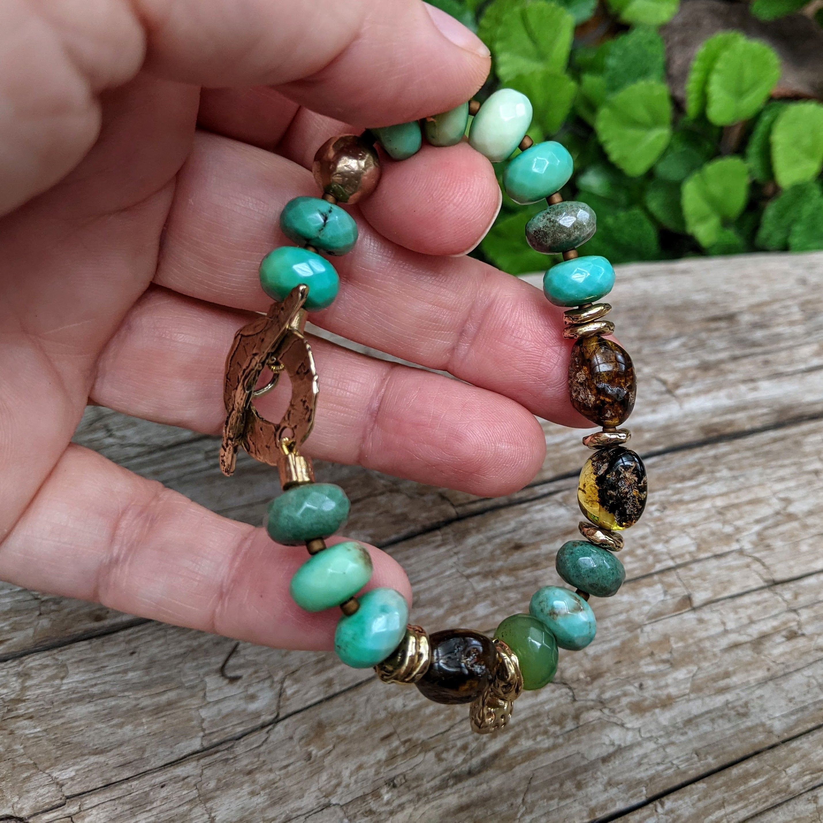 Grass green chrysoprase artisan bracelet with raw Baltic amber and gold bronze heart charm. Organic, rustic, handmade bracelet. Handcrafted by Aurora Creative Jewellery.