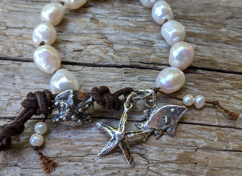 Handmade Boho Natural Baroque Pearl Leather Bracelet with Fish and Starfish Charms - a fun and chic bracelet showcasing the beauty of large white baroque pearls complemented by artisan sterling silver charms and rustic leather