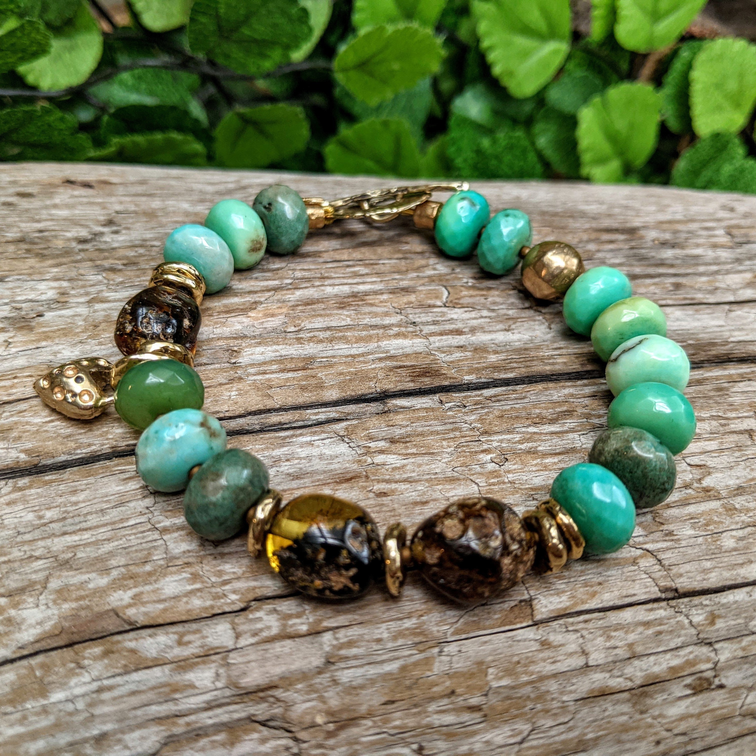 Apple green chrysoprase artisan bracelet with raw Baltic amber and gold bronze heart charm. Organic, rustic handmade bracelet. Handcrafted by Aurora Creative Jewellery.