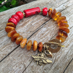 Genuine Baltic amber bracelet. Honey amber and coral bracelet. Artisan handmade bracelet. Bee charm bracelet. Handcrafted by Aurora Creative Jewellery.
