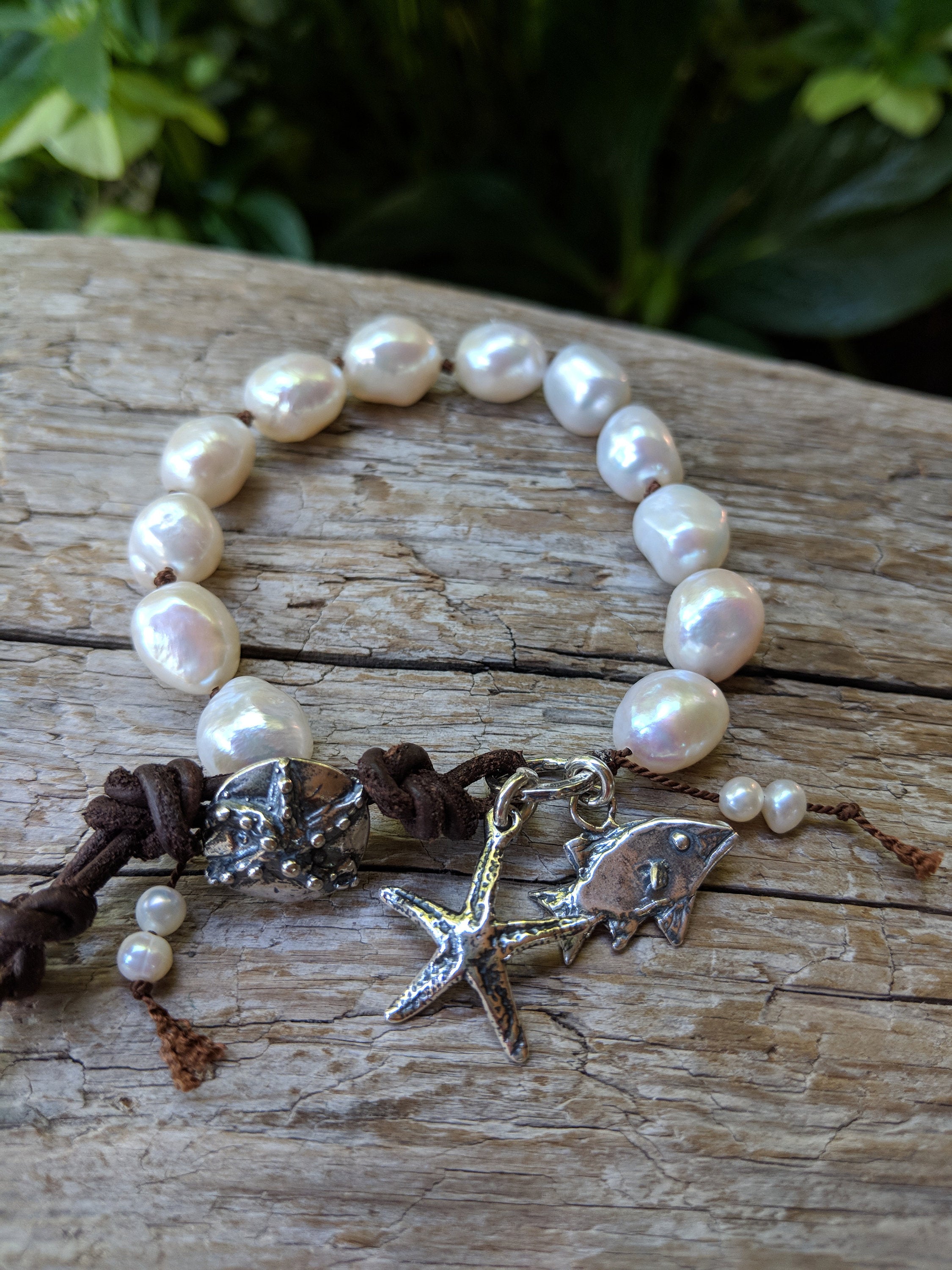 Handmade Boho Natural Baroque Pearl Leather Bracelet with Fish and Starfish Charms - a fun and chic bracelet showcasing the beauty of large white baroque pearls complemented by artisan sterling silver charms and rustic leather