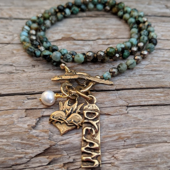 African turquoise necklace with pyrite, freshwater pearl, dream and heart charms, by Aurora Creative Jewellery