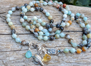 A gorgeous handmade artisan one-of-a-kind long amazonite necklace radiating earth tones and relaxing beach vibes. You can wear this necklace as a long statement piece or wrap it around your neck twice. Use the clasp to open the necklace if you want to wrap it. There is a beautiful turtle charm to compliment the sand and ocean tones of amazonite. The focus point near the clasp has a lovely star linker, and chalcedony and citrine briolette pendants for a refreshing pop of color.