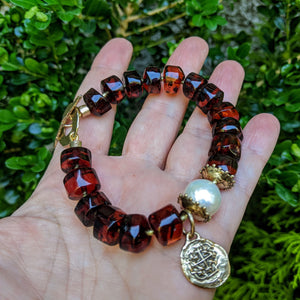 Baltic amber beaded bracelet with gold bronze Spanish coin and big Edison pearl handcrafted Aurora Creative Jewellery.