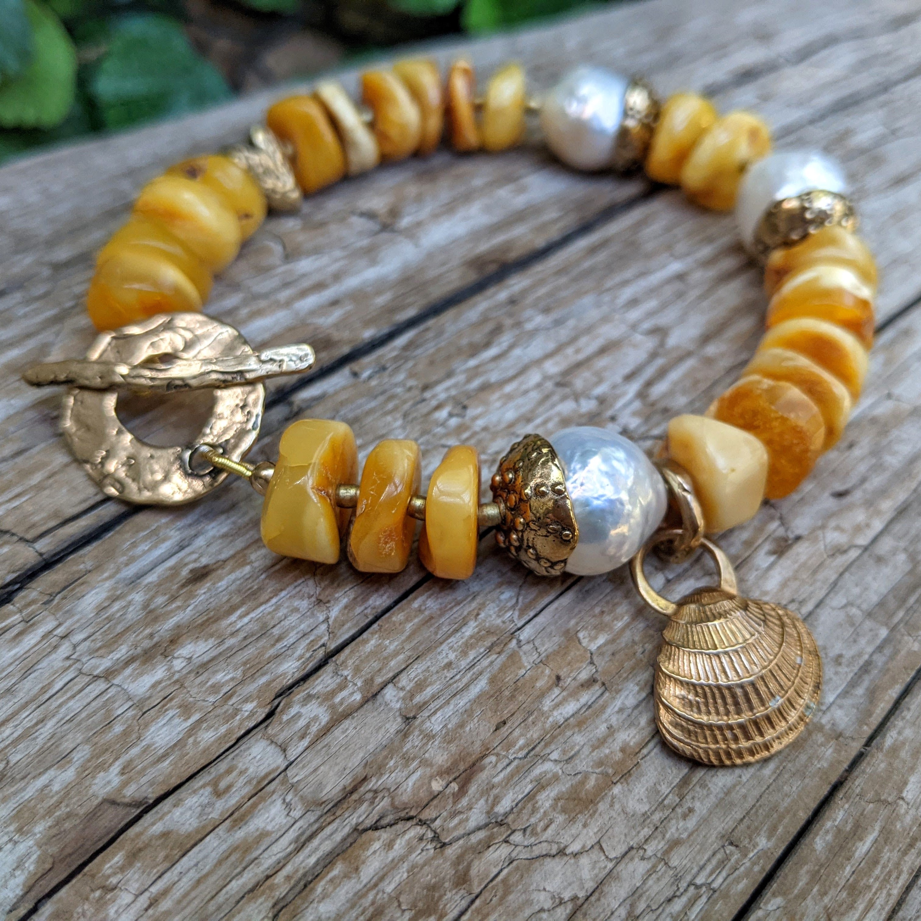 Butterscotch Baltic amber artisan bracelet with big white Edison pearl handcrafted by Aurora Creative Jewellery.