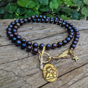 Black pearl boho necklace with Angel Cherub Rafael pendant. Artisan rustic necklace handcrafted by Aurora Creative Jewellery.