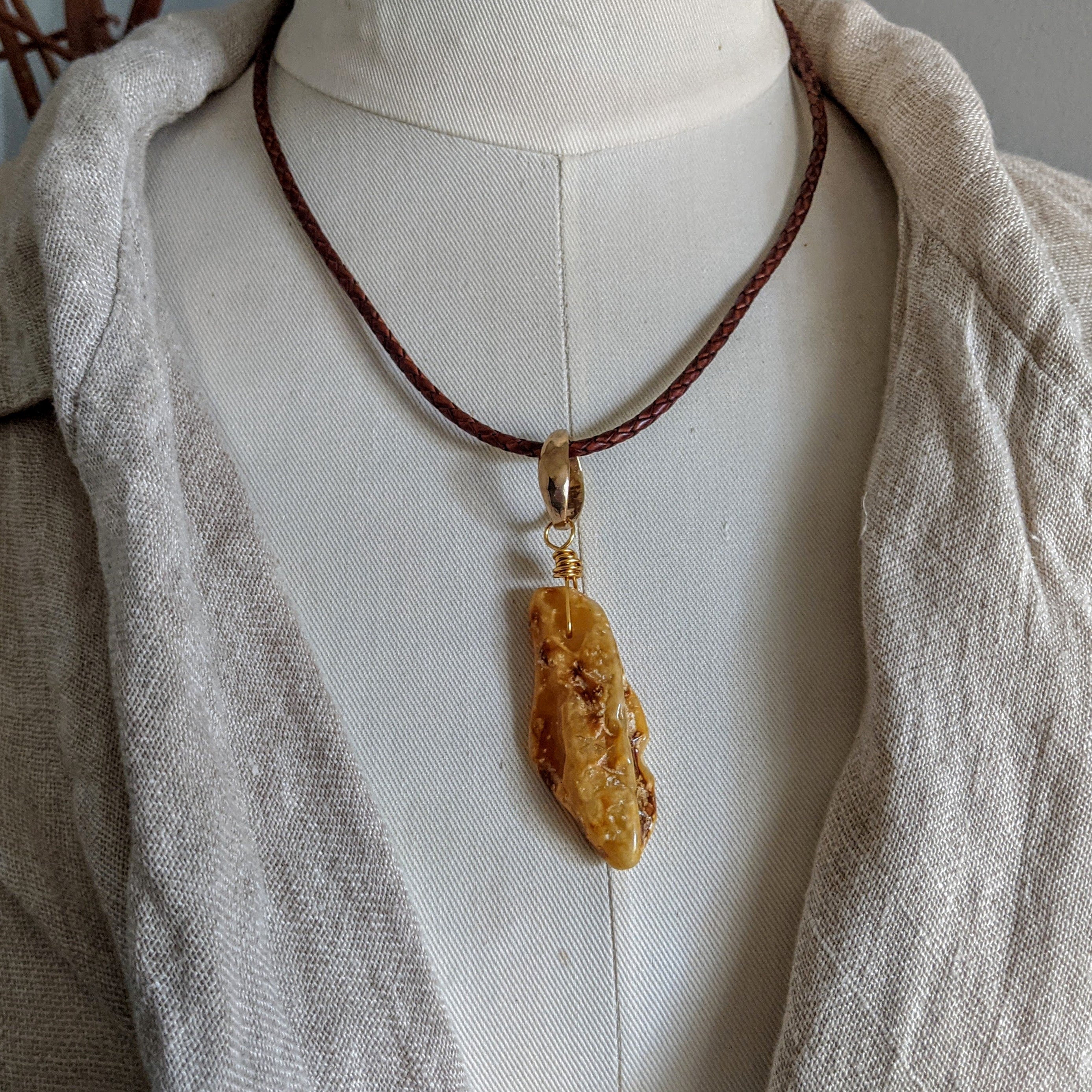 Buttersctch amber rustic pendant. Leather amber necklace. Earthy organic jewelry. Handcrafted by Aurora Creative Jewellery.
