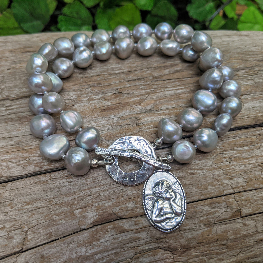 Multi strand grey pearl bracelet. Angel charm bracelet. Artisan pearl bracelet. Handcrafted by Aurora Creative Jewellery. 