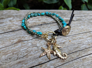 Handmade artisan turquoise gemstone and pyrite button bracelet with gold bronze seahorse and starfish charms by Aurora Creative Jewellery