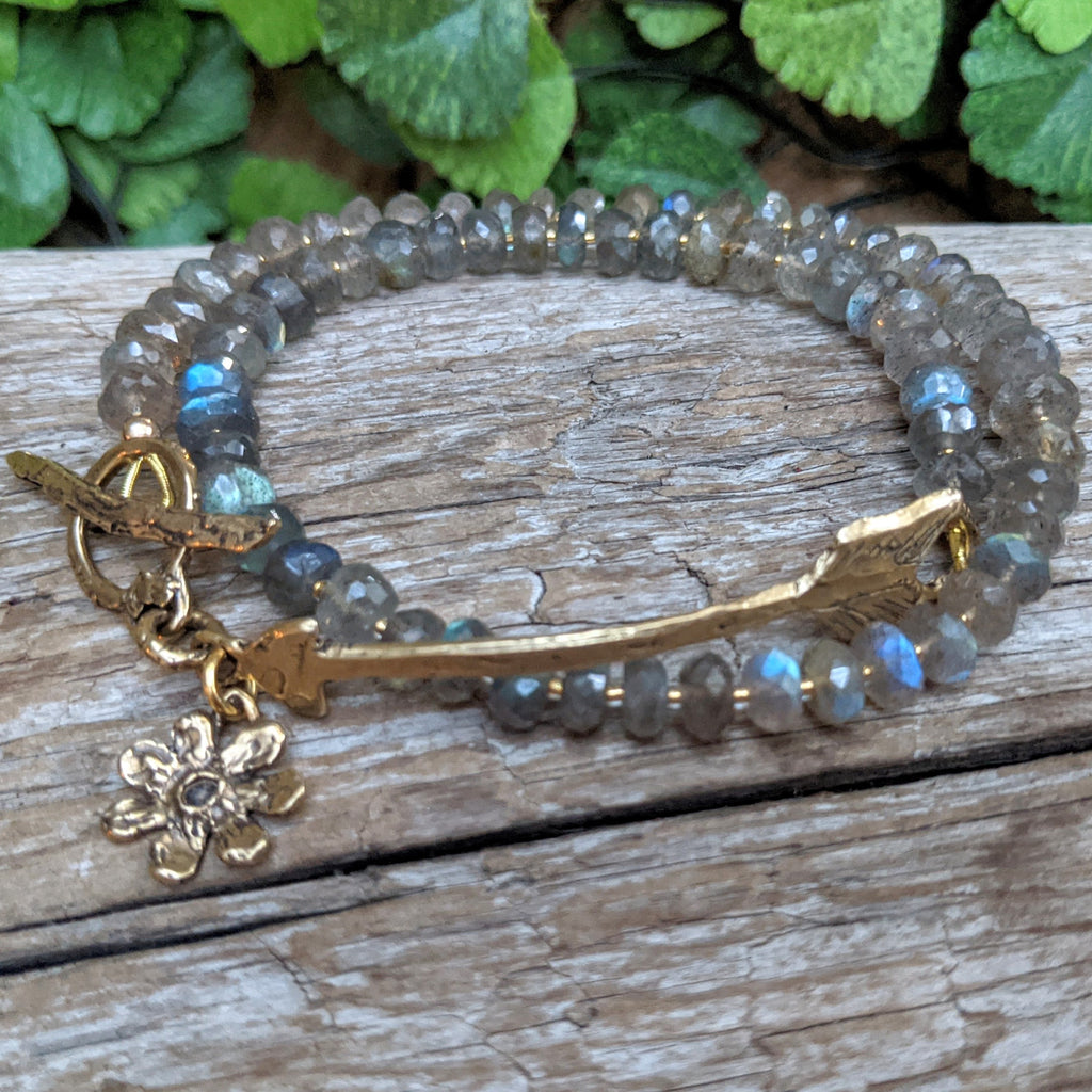Handmade artisan labradorite gemstone wrap bracelet with hammered gold bronze arrow, toggle, and flower charm, designed and handcrafted by Aurora Creative Jewellery