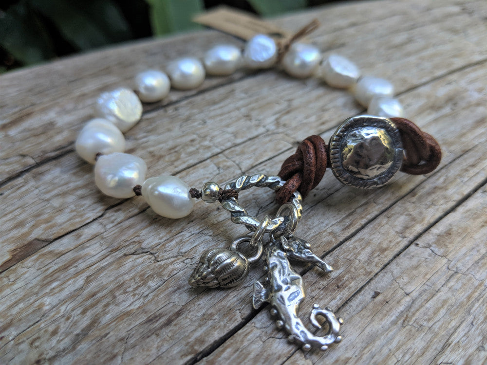 Large white baroque pearl button handmade artisan bracelet with silver seahorse and sea shell charms by Aurora Creative Jewellery