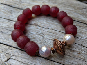 Burgundy recycled glass elastic bracelet with soft pink Edison pearls. Beautiful to wear on its own or in a stack! By Aurora Creative Jewellery