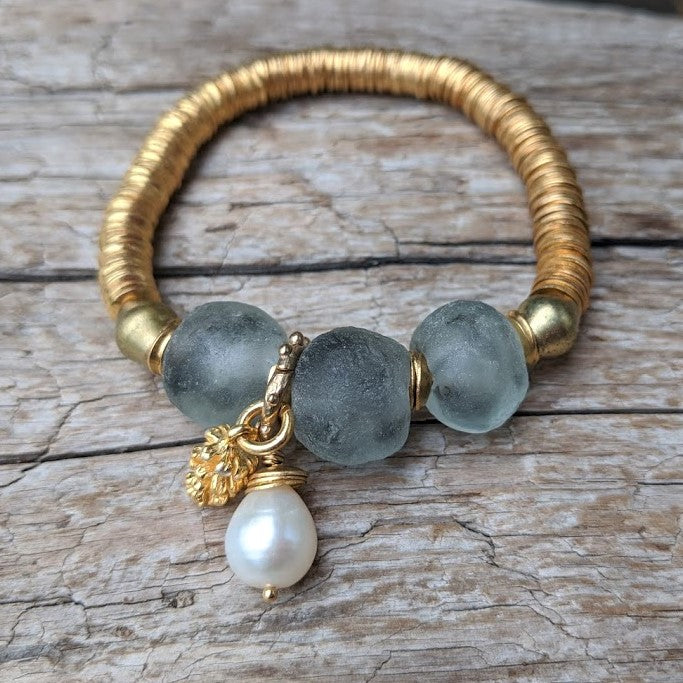 Handmade gray blue recycled glass bracelet with gold pine cone charm and white baroque pearl by Aurora Creative Jewellery
