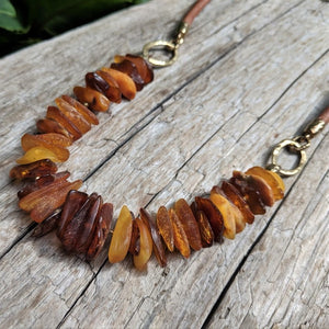 Handmade raw Baltic amber chip and leather necklace by Aurora Creative Jewellery