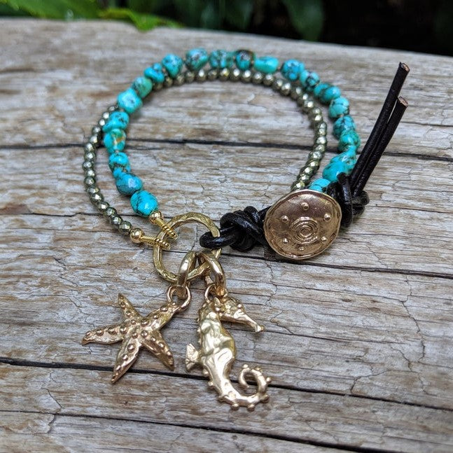 Handmade artisan turquoise gemstone and pyrite button bracelet with gold bronze seahorse and starfish charms by Aurora Creative Jewellery