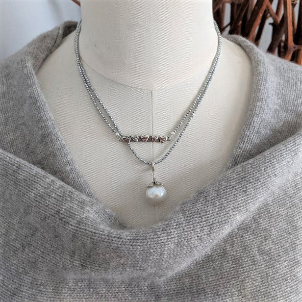 Thin silver hematite gemstone and large white Edison pearl pendant necklace by Aurora Creative Jewellery