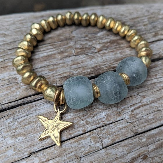 Handmade blue gray recycled glass bracelet with gold African brass and artisan gold bronze star charm by Aurora Creative Jewellery