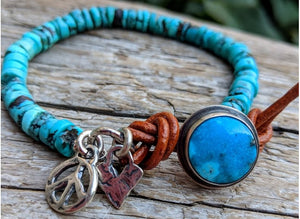 This handmade artisan turquoise bracelet showcases the Tibetan turquoise beads and turquoise button complimented by artisan sterling silver elements including the peace charm and a tiny heart. The button on this bracelet is unique as it has sterling silver setting. The button gets inserted into the leather loop to close the bracelet. A beautiful bright turquoise on your wrist contrasted by a terracotta leather accent is a perfect summer accessory. 
