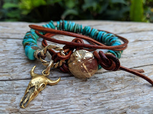 This fun handmade artisan one-of-a-kind wrap bracelet showcases the natural bright Tibetan turquoise, complimented by leather and gold bronze elements. In a modern take on gemstone jewelry we combine charms with leather accents to complement the texture of the stone. The large gold bronze cow skull charm adds a unique touch and creates a western cowgirl theme. 