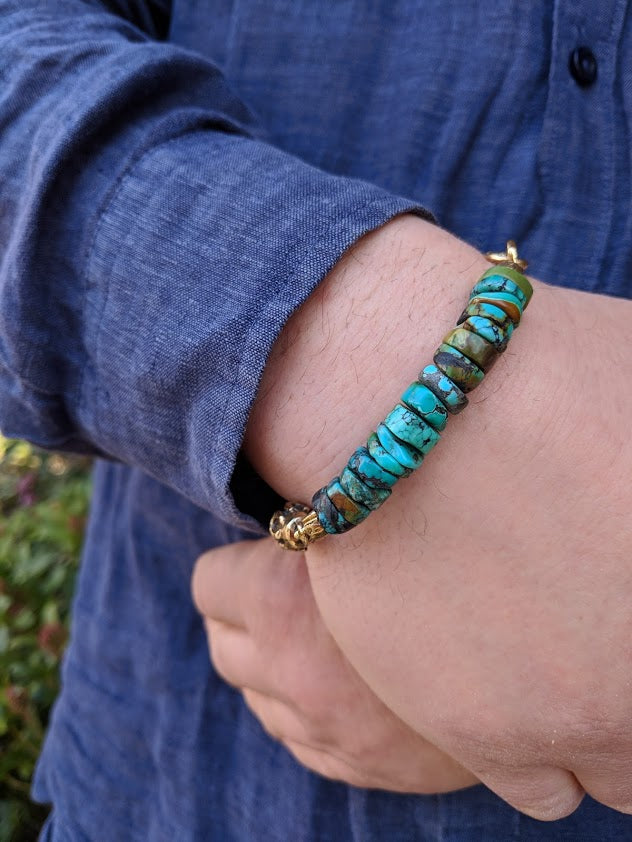A handmade artisan bracelet featuring turquoise combined with thick brown leather and gold bronze elements. The leather is thick, yet very flexible and comfortable to wear. The bracelet has a rough chunky look making it a perfect bracelet for men or a unisex accessory for the lovers of a chunky organic look. 
