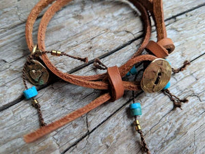 This fun handmade artisan boho leather wrap bracelet showcases the beauty of natural textures. The vibrant natural turquoise gives a pop of color on the background of natural leather.  The bracelet is finished off with a gold bronze button and leather loop. A heart charm adds another touch of gold and an element of fun. The heart charm can freely move around the bracelet so you can enjoy it from all sides. 