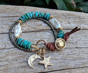 This gorgeous handmade artisan bracelet features turquoise gemstone, pyrite, and baroque pearls highlighted with artisan gold bronze elements. The star and crescent moon charms together create a starry night theme, making you feel like you are taking a night walk along the tropical beach. 
